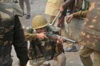 Police in Meerut, Uttar Pradesh, take aim at angry crowds demonstrating against the citizenship law