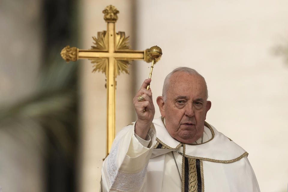 Pope Francis asperses holy water as he celebrates Easter mass in St. Peter's Square at the Vatican, Sunday, March 31, 2024. (AP Photo/Andrew Medichini)