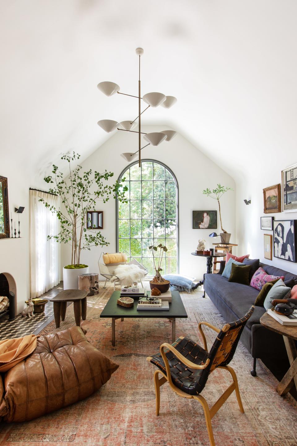 In the living area of a 1920s Tudor home in San Marino, California, Carter Design brought in an eclectic mix of old and new, including a 1920s Khotan rug, a custom BDDW sofa, a Poul Kjaerholm coffee table, and chairs by Hans Wegner, Bruno Mathsson, and Ligne Roset. The gallery wall combines 19th-century paintings with drawings by the clients’ children.