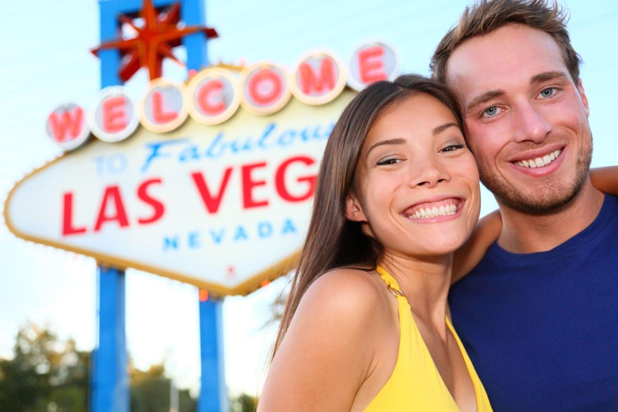 couple in front of Las Vegas sign