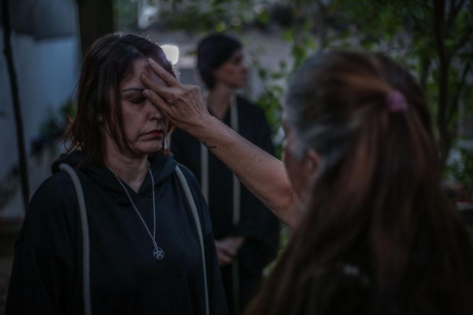 A Wiccan high priestess blesses another priestess during a seasonal sabbat in honor of Brigid, a Celtic goddess, in 2020 in Rio de Janeiro. <a href="https://www.gettyimages.com/detail/news-photo/jussara-gabriel-a-wiccan-high-priestess-blesses-the-first-news-photo/1228124551?adppopup=true" rel="nofollow noopener" target="_blank" data-ylk="slk:Andre Coelho/Getty Images;elm:context_link;itc:0;sec:content-canvas" class="link ">Andre Coelho/Getty Images</a>
