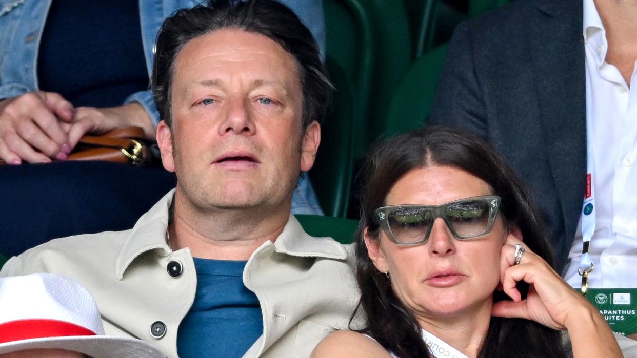 Jamie Oliver's wife Jools leaning against him at the tennis 