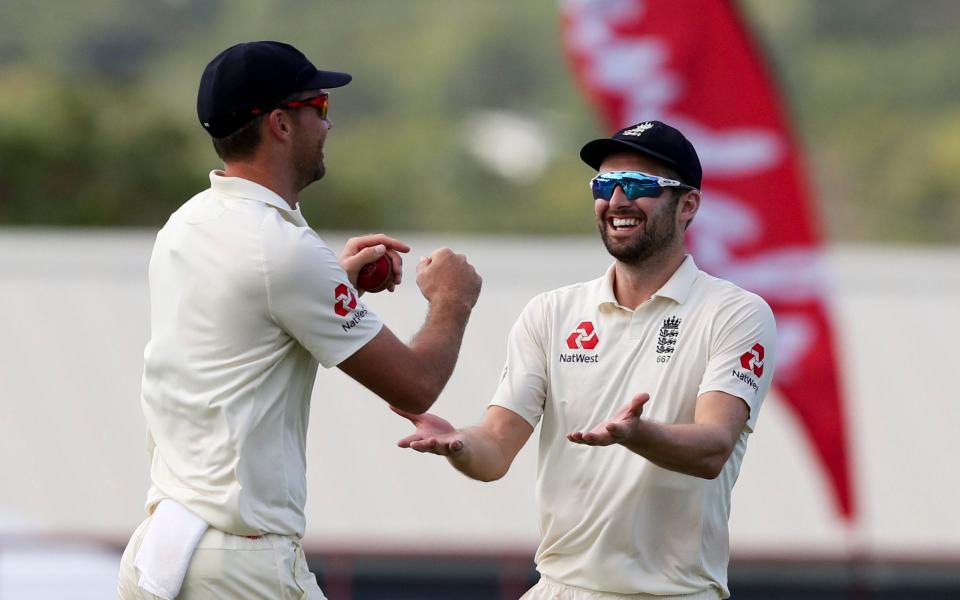 James Anderson takes the catch to dismiss Alzarri Joseph and Mark Wood joins the celebrations - AP