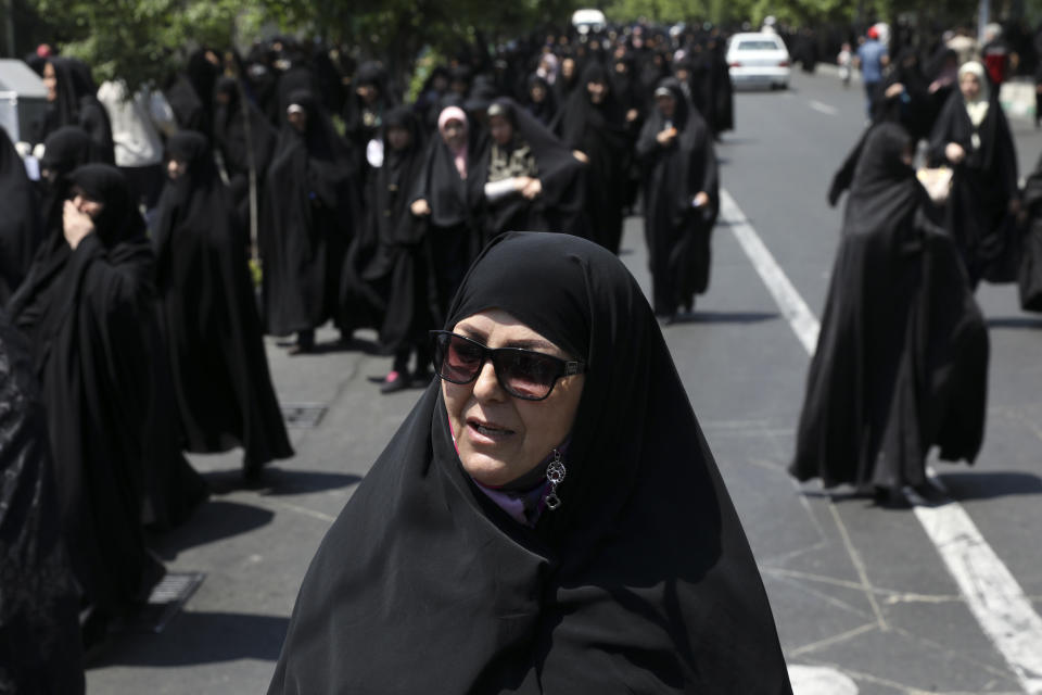 In this Friday, May 17, 2019 photo, housewife Zoherh Sadeghi speaks during an interview at the conclusion of Friday prayers in Tehran, Iran. "If America could do anything, it would have done many things by now. ... It can't do anything. It can't do a damn thing," she says. (AP Photo/Vahid Salemi)