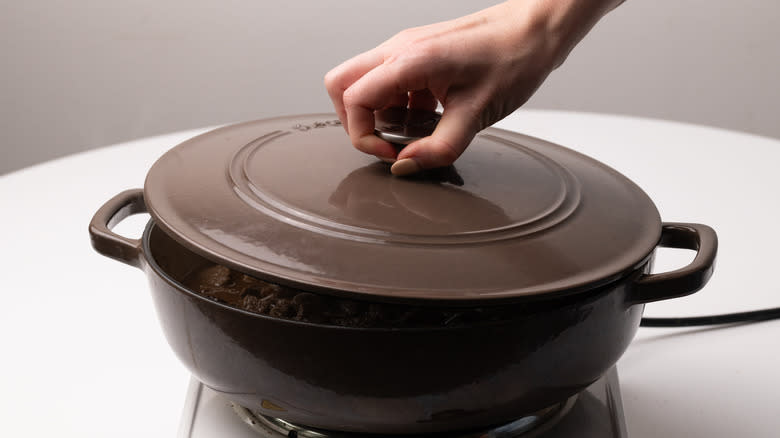 Putting lid on skillet pan