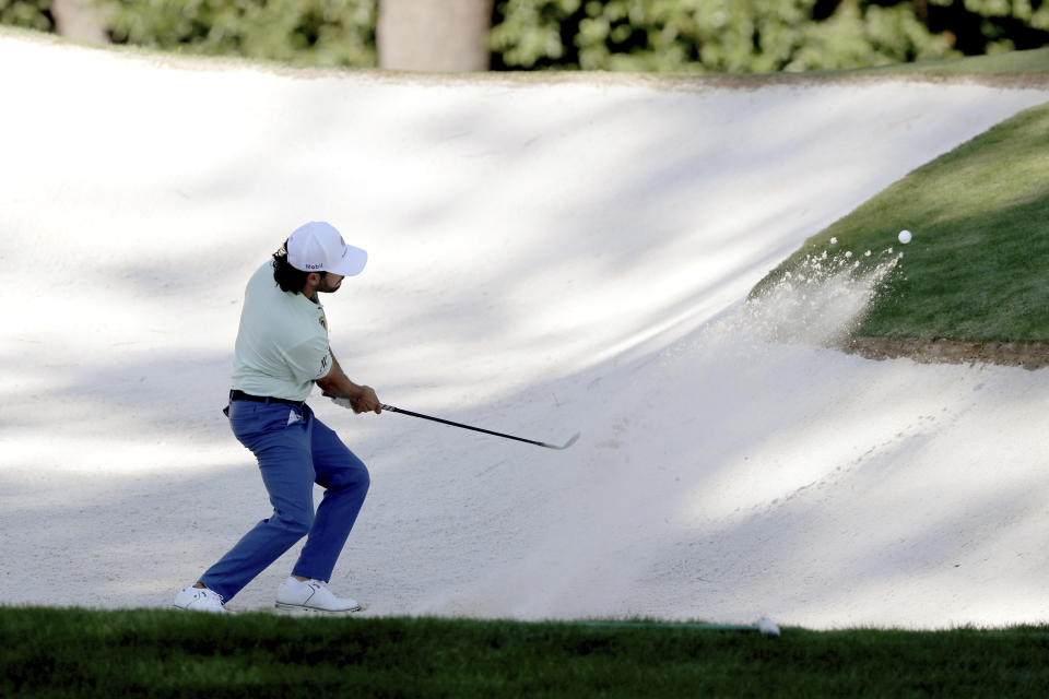 Abraham Ancer hits his bunker shot on the 3rd hole during the second round of the Masters Friday, Nov. 13, 2020, in Augusta, Ga. (Curtis Compton/Atlanta Journal-Constitution via AP)