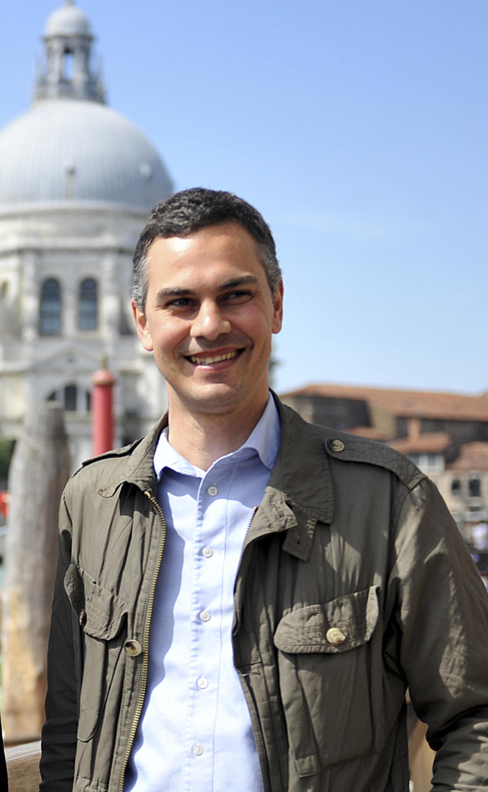 In this photo taken on May 25 2013, Biennale curator Massimiliano Gioni poses for photos in Venice, Italy. Massimiliano Gioni is the youngest curator ever at the world's oldest contemporary art fair — the Venice Biennale. Yet it is not so much his relative youth, at age 39, that gives him an edge as he presents the main show of the prestigious event that can make or break the careers of the artists who are exhibited, but his experience. "I wanted to make a show that is open to people who are not expected to be in the Biennale. If with youth comes innovation, I am happy," Gioni said in an interview. "Youth for the sake of youth is always a way to brand products." (AP Photo/Luigi Costantini)