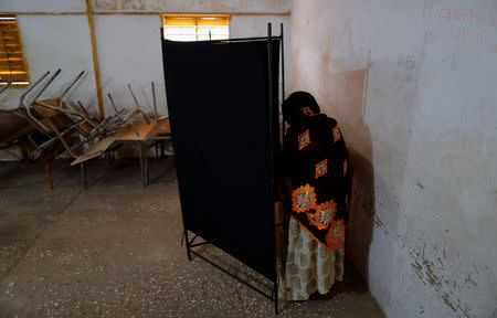 A woman casts her vote during presidential election, at a polling station in Fatick, Senegal February 24, 2019. REUTERS/Zohra Bensemra