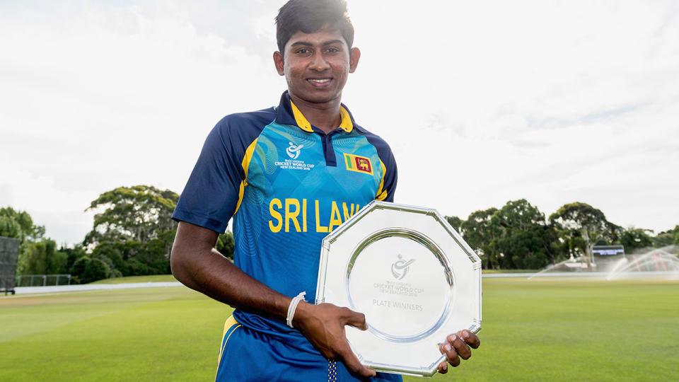 Kamindu Mendis poses with the trophy after their win in the ICC U19 Cricket World Cup Plate Final. (Photo by Kai Schwoerer-IDI/IDI via Getty Images)