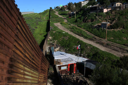 A shack stands next to a section of the border fence separating Mexico and the United States, in Tijuana, Mexico. REUTERS/Edgard Garrido