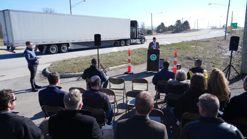 As another truck rolls by his news conference, Toni Turowski of The Ohio Department of Transportation (ODOT) District Six announces upcoming projects and traffic impacts for the central Ohio region. ODOT held the news conference alongside Rt. 29 near a new roundabout with Interstate 70 in Madison County.
