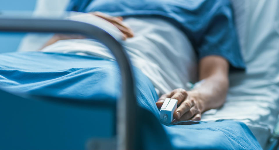 a man in a hospital bed being treated for Covid