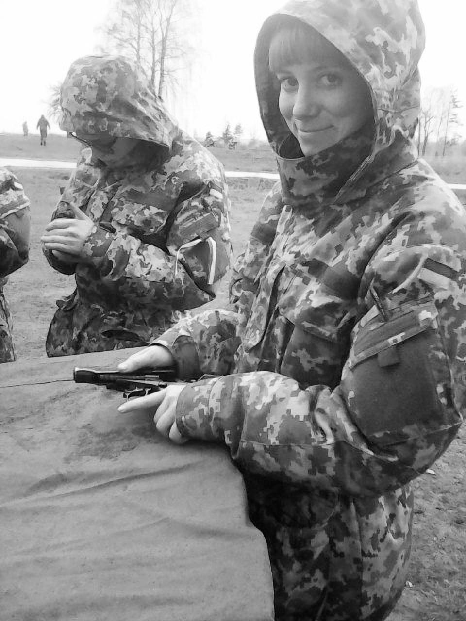 Olya, a young mother from Ukraine who has left her baby behind, trains on weapons for the front in Donbas. (Macmillan)