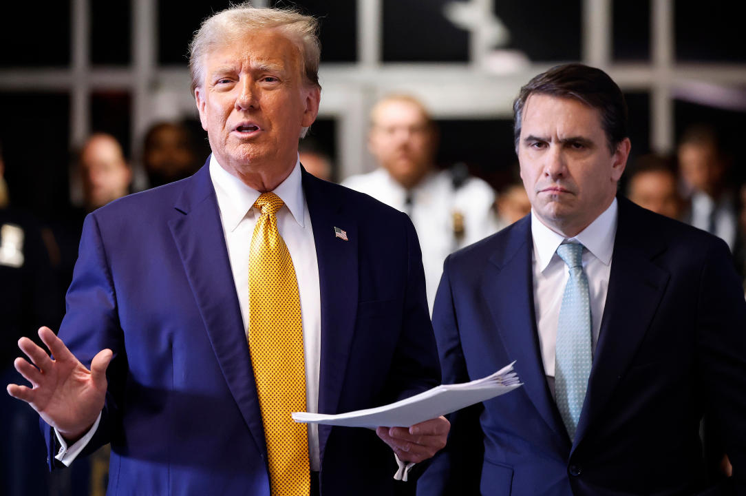 Former President Donald Trump, left, and his attorney, Todd Blanche, speak to members of the media while arriving at the Manhattan Criminal Courthouse.