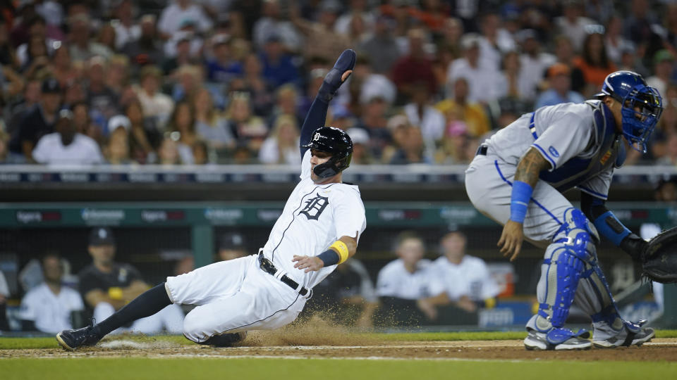 Detroit Tigers' Ryan Kreidler scores as Kansas City Royals catcher Salvador Perez waits for the throw in the fifth inning of a baseball game in Detroit, Friday, Sept. 2, 2022. (AP Photo/Paul Sancya)