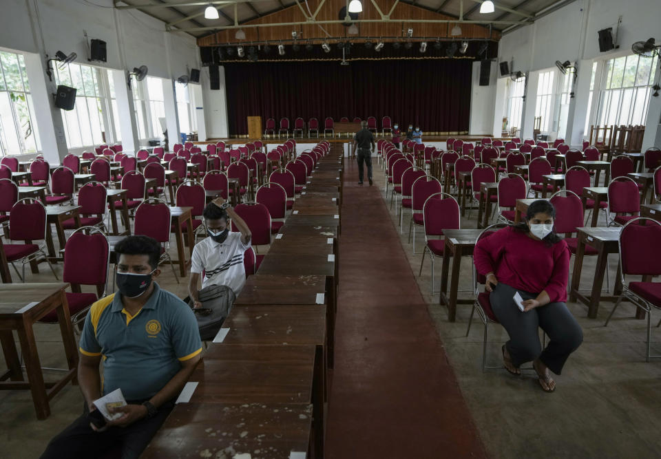 Sri Lankan university students wait to receive their coronavirus vaccine at the Sri Jayawardenapura university in Colombo, Sri Lanka, Monday, Oct. 11, 2021. (AP Photo/Eranga Jayawardena)