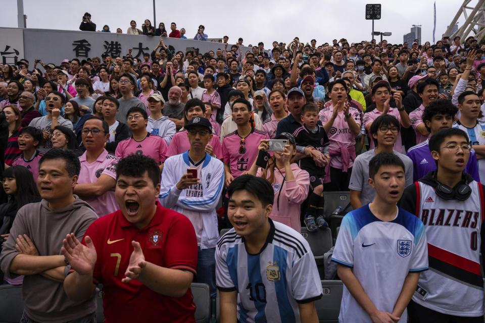 Supporters cheer during the friendly football match between Hong Kong Team and US Inter Miami CF at the Hong Kong Stadium in Hong Kong, Sunday, Feb. 4, 2024. (AP Photo/Louise Delmotte)