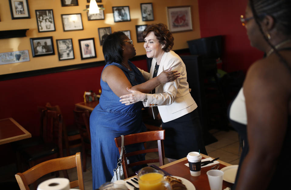 In this Sept. 29, 2018, photo, Rep. Jacky Rosen, D-Nev., right, embraces Carmen West during a breakfast event at TC's Rib Crib as she campaigns in Las Vegas. In the high-stakes race for Senate in Nevada, Rosen is taking on one of the biggest names in GOP politics by painting Sen. Dean Heller as someone without firm principles. (AP Photo/John Locher)