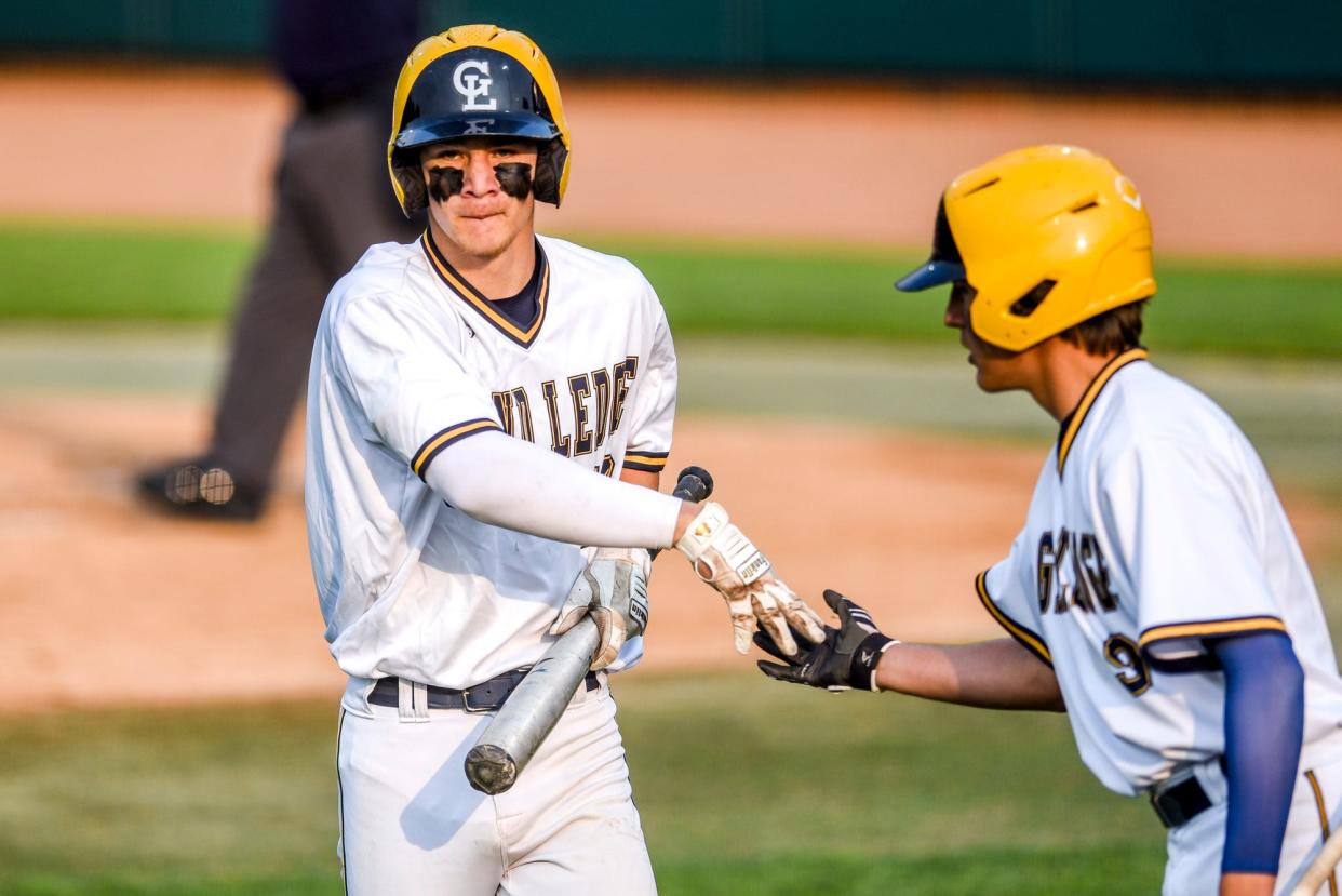 Grand Ledge's Preston Bohnet, left, celebrates his run with teammate Alex Cornman in the first inning during the game against Olivet on Monday, June 5, 2023, at McLane Stadium on the Michigan State University campus in East Lansing.
