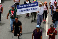 Opposition supporters rally against President Nicolas Maduro with a sign that reads "Do not kill us, we want to vote" in Caracas, Venezuela May 24, 2017. REUTERS/Carlos Garcia Rawlins