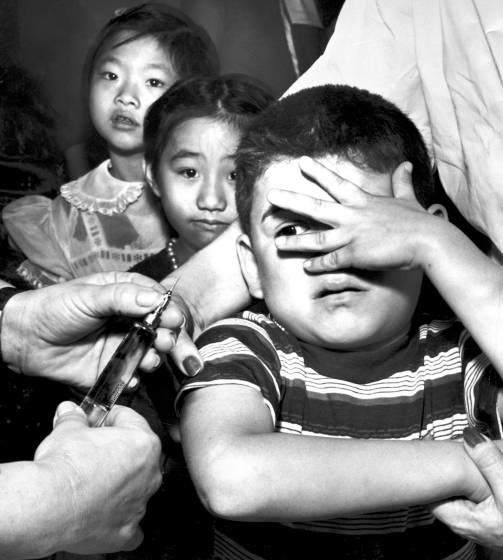 Children in 1957 receive polio vaccine shots.