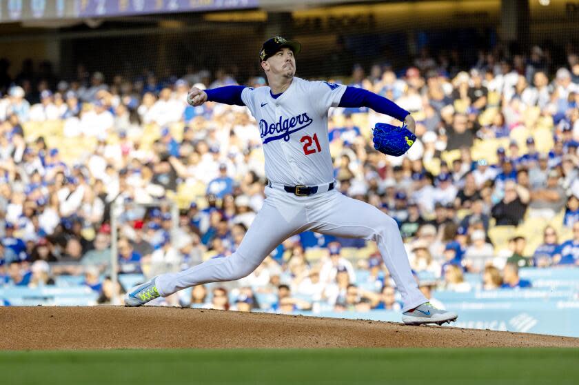 Dodgers pitcher Walker Buehler (21) delivers the ball during a victory over the Cincinnati Reds on Saturday
