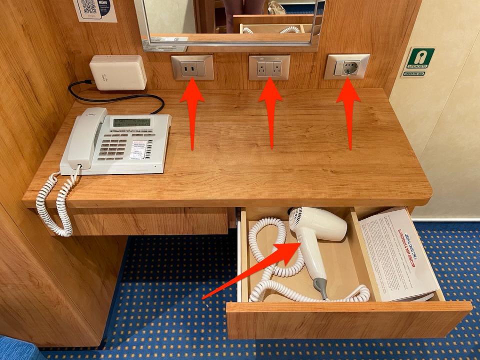Arrows points to the cruise cabin's outlets and hairdryer.