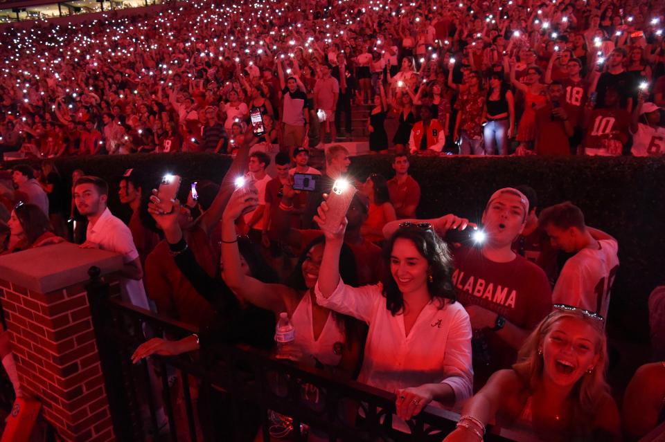 Bryant-Denny Stadium is illuminated in crimson colored light and with fans holding cellphones high during the Sept. 3, 2022,  game with Utah State at Bryant-Denny Stadium.