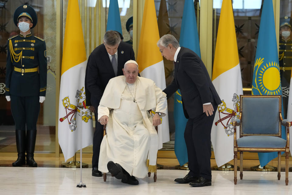 Pope Francis, left, meets the Kazakhstan's President Kassym-Jomart Tokayev as he arrives at Our-Sultan's International airport in Nur-Sultan, Kazakhstan, Tuesday, Sept. 13, 2022. Pope Francis begins a 3-days visit to the majority-Muslim former Soviet republic to minister to its tiny Catholic community and participate in a Kazakh-sponsored conference of world religious leaders. (AP Photo/Andrew Medichini)