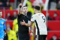 Fulham's Aleksandar Mitrovic is ordered to leave the field after he was shown red card during the English FA Cup quarterfinal soccer match between Manchester United and Fulham at the Old Trafford stadium in Manchester, England, Sunday, March 19, 2023. (AP Photo/Jon Super)