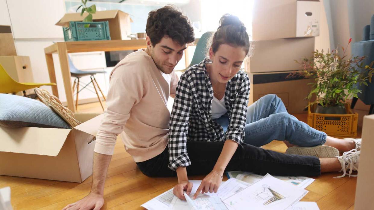 A couple looking at plans of their new home