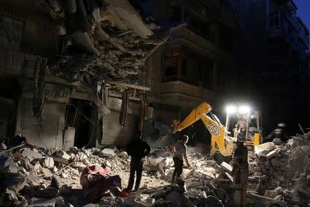 Civil Defense members search for survivors at a site hit by an airstrike in the rebel-held al-Shaar neighbourhood of Aleppo, Syria, September 27, 2016. REUTERS/Abdalrhman Ismail