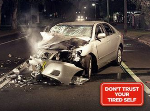 Driving tired graphic showing smashed car and urging drivers not to trust their tired self.