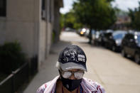 Ethel Watts, 80, makes the half-mile walk home with fresh groceries from a food distribution site at St. Sabina Catholic Church in the Auburn Gresham neighborhood in Chicago, Thursday, Aug. 27, 2020. Auburn Gresham has faced hard times before. Guns are easy to find. Fresh produce isn't. Poverty hovers around 20 percent. But there's never been anything like this: A once-in-a-century epidemic in a community without a hospital. (AP Photo/David Goldman)