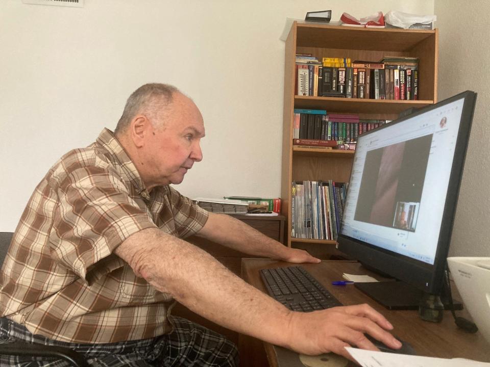 Vlad Brodsky of Springfield talks to friends in Ukraine via Facebook messenger on Thursday in the aftermath of the full-scale Russian invasion of that country. Brodsky came to Springfield from Ukraine with his parents in 1994. [Steven Spearie/The State Journal-Register]