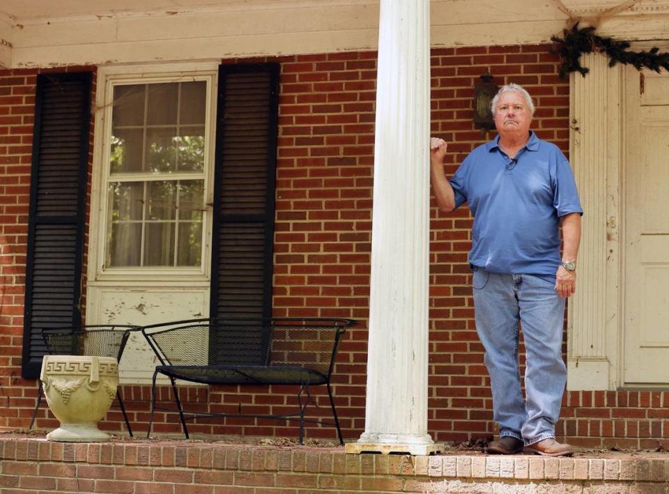 Ronnie Roberts, son of Melvin Roberts, stands on his father’s front porch in June. Ronnie Roberts believes there was an accomplice who helped murder his father in February, 2004