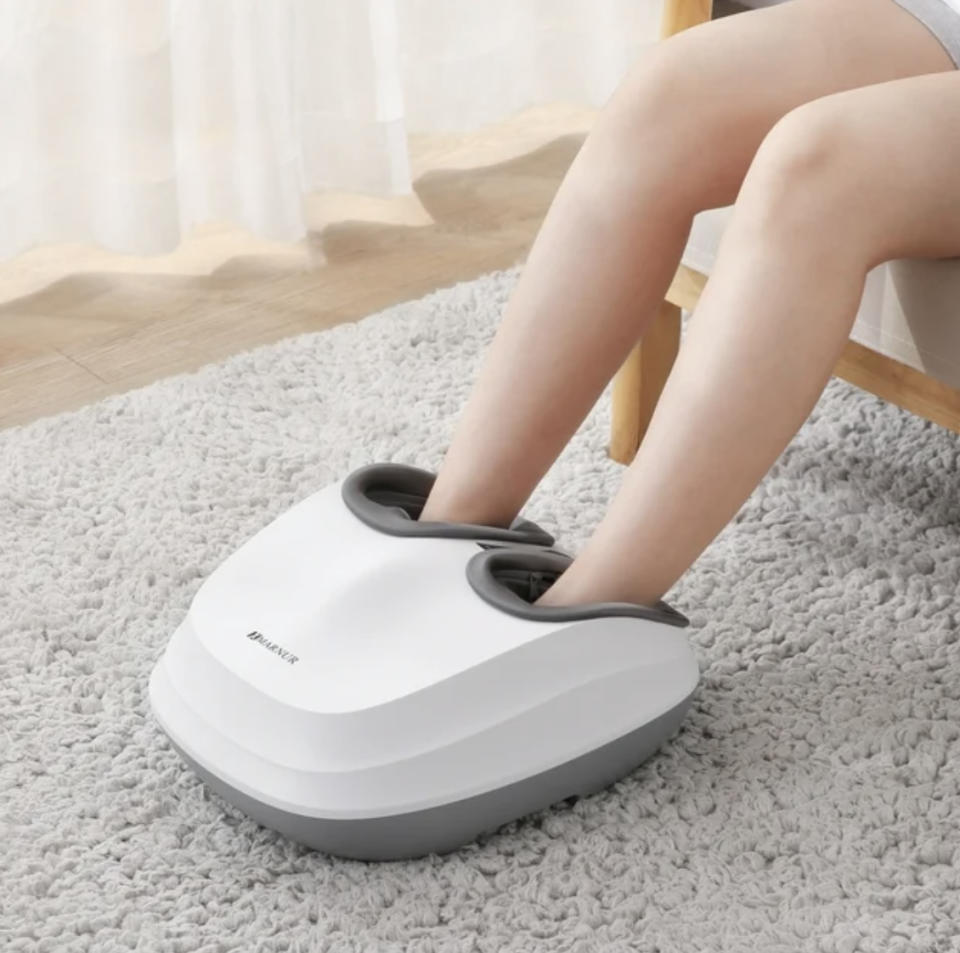 Person using a foot massager while seated