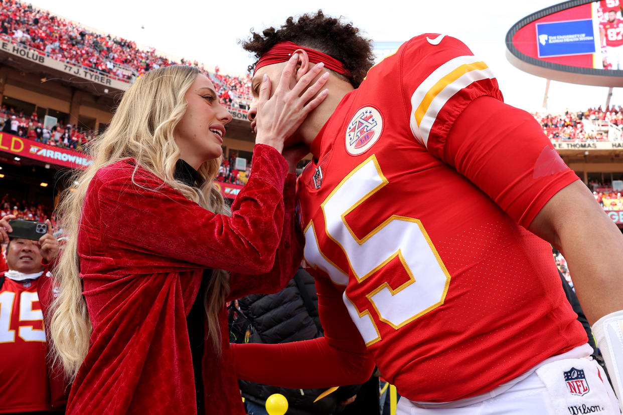 KANSAS CITY, MISSOURI - JANUARY 30: Quarterback Patrick Mahomes #15 of the Kansas City Chiefs kisses his finance Brittany Matthews before the start of the  AFC Championship Game against the Cincinnati Bengals at Arrowhead Stadium on January 30, 2022 in Kansas City, Missouri. (Photo by Jamie Squire/Getty Images)