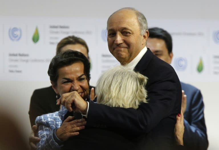 Foreign Affairs Minister Laurent Fabius (R) hugs French Ambassador for COP21 Laurence Tubiana, at the Climate Conference in Le Bourget, north of Paris, on December 12, 2015