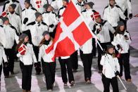 <p>Denmark’s flag bearer Elena Moller Rigas leads the delegation as they parade wearing minimalsitic white winter jackets, black pants, and gray beanies during the opening ceremony of the 2018 PyeongChang Games. (Photo: Martin Bureau/AFP/Getty Images) </p>