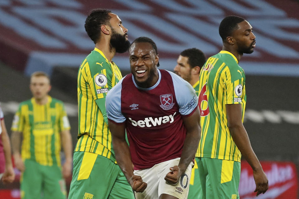 West Ham's Michail Antonio, centre, celebrates after scoring his side's second goal during an English Premier League soccer match between West Ham and West Bromwich Albion at the London Stadium in London, England, Tuesday Jan.19, 2021. (Matthew Childs/Pool via AP)