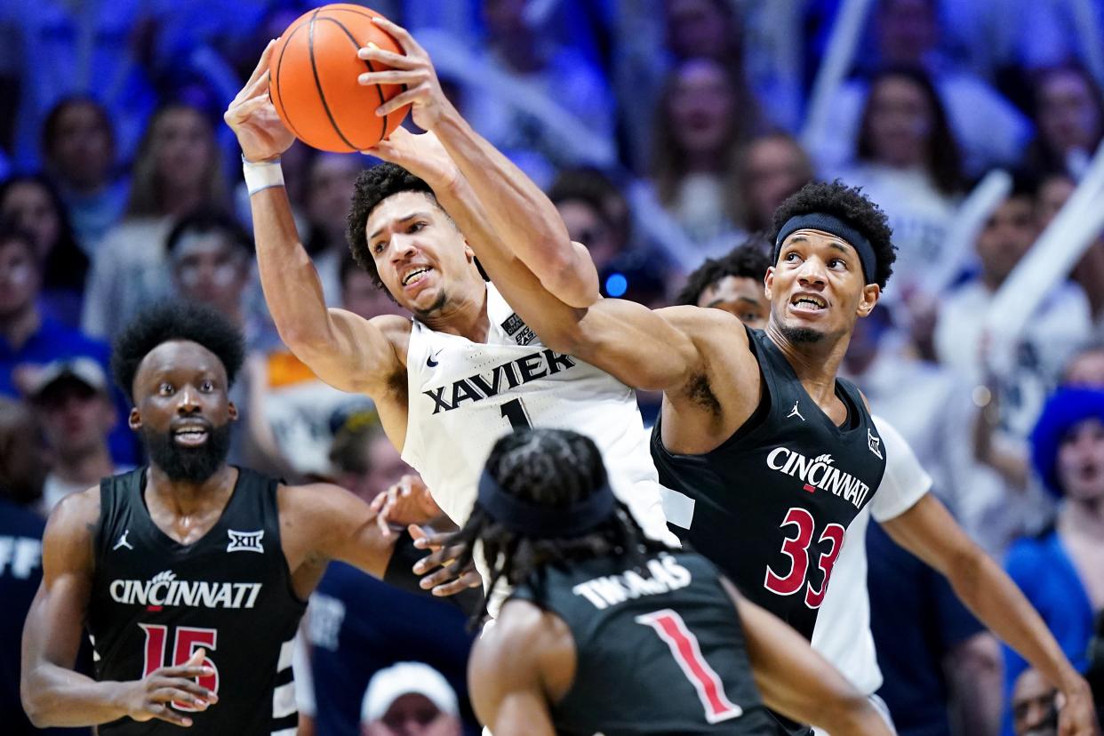 Xavier guard Desmond Claude and Cincinnati forward Ody Oguama