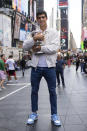 U.S. Open men's singles tennis champion Carlos Alcaraz poses in Times Square, Monday, Sept. 12, 2022, in New York. (AP Photo/Yuki Iwamura)