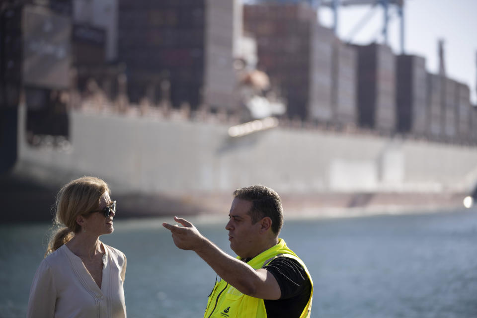 U.S. Agency for International Development Administrator Samantha Power, left, talks to Robt Pellech, manager of the containers department of Ashdod port as they visit the area where cargo ships arrive, carrying humanitarian aid for Gaza Strip, in Ashdod, Israel, Thursday, July 11, 2024. (AP Photo/Leo Correa)