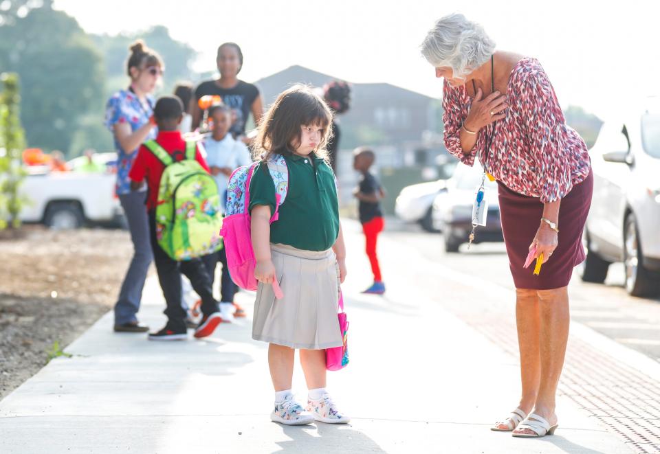 Anna Mary Byrd tries to coax a disgruntled first-time student into Perry Elementary Wednesday morning. Aug. 9, 2023. 