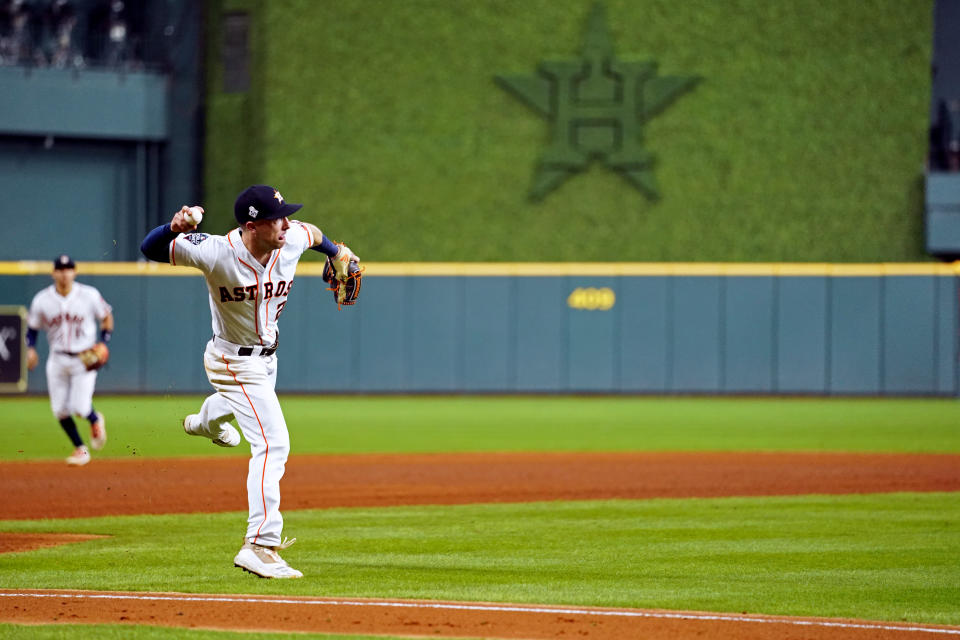 HOUSTON, TX - OCTOBER 23:  Alex Bregman #2 of the Houston Astros fields a ground ball but makes a throwing error in the seventh inning during Game 2 of the 2019 World Series between the Washington Nationals and the Houston Astros at Minute Maid Park on Wednesday, October 23, 2019 in Houston, Texas. (Photo by Cooper Neill/MLB Photos via Getty Images)