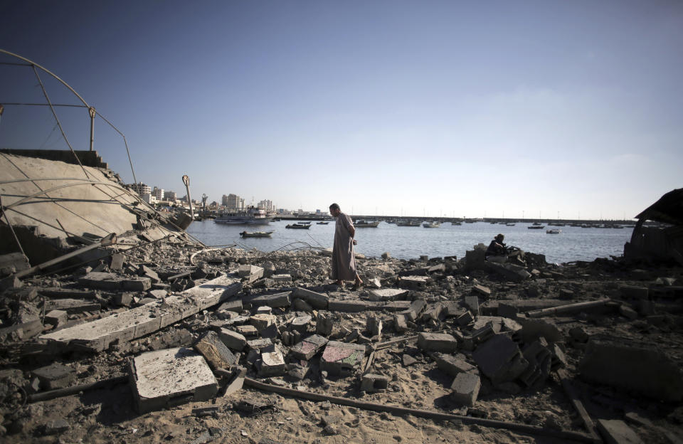 FILE - A Palestinian man inspects the damage at a police post following an Israeli missile strike that killed four boys from the same extended Bakr family, in Gaza City, July 16, 2014. Israel’s Supreme Court on Sunday, April 24, 2022 rejected a request to reopen an investigation into the deaths of the four Palestinian children who were killed by an Israeli airstrike while playing on the beach in the Gaza Strip during a 2014 war. (AP Photo/Khalil Hamra)