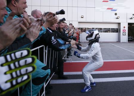 Formula One - F1 - Russian Grand Prix - Sochi, Russia - 30/04/17 - Mercedes Formula One driver Valtteri Bottas of Finland celebrates the victory with team members after the race. REUTERS/Maxim Shemetov