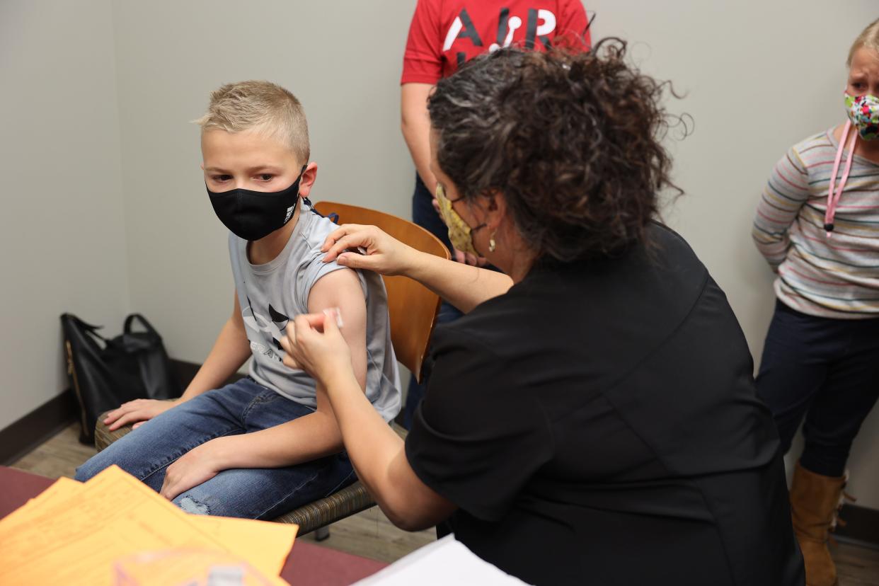 Owen Rantilla, 9, from Rootstown gets his first dose of the COVID-19 vaccine at NEOMED’s COVID-19 clinic for 5-11 year olds.