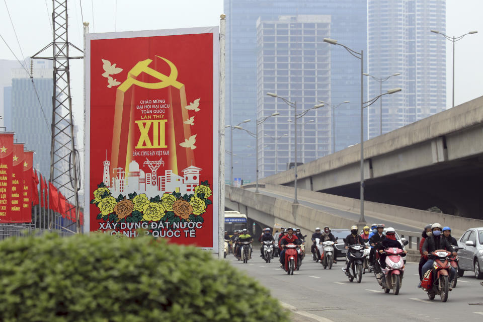In this Jan. 19, 2016, photo traffic ride past a Communist party poster in Hanoi, Vietnam. Vietnam's selection as the venue for the second summit between U.S. President Donald Trump and North Korean leader Kim Jong Un is largely a matter of convenience and security, but not without bigger stakes. Vietnam's history as a U.S. adversary in a long, divisive war that transitioned on its own terms to a dynamic free-market economy under a communist political system suggests a larger meaning for the summit. (AP Photo/Hau Dinh)